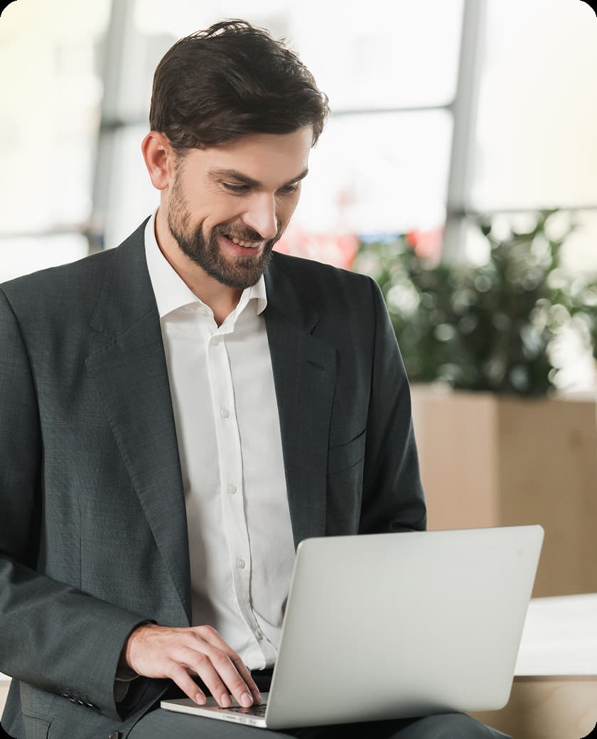 person working on a laptop with a smile on the face